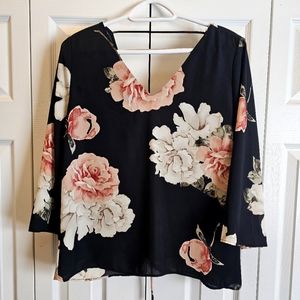 Sheer open-back black and floral blouse